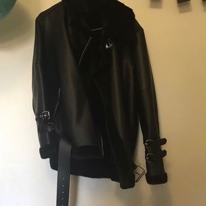 Oversized leather coat with fur lining.